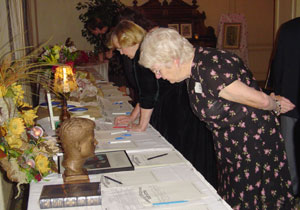Joan Braden, checking out the auction table