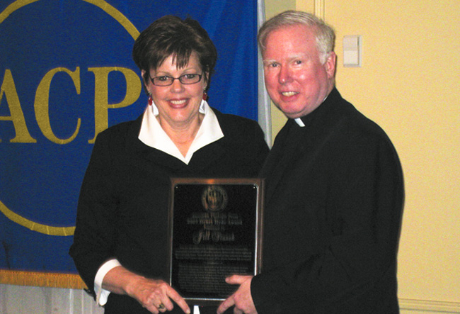 Jill Stanek (left) receives the Henry Hyde Award from Father Gilligan (right)