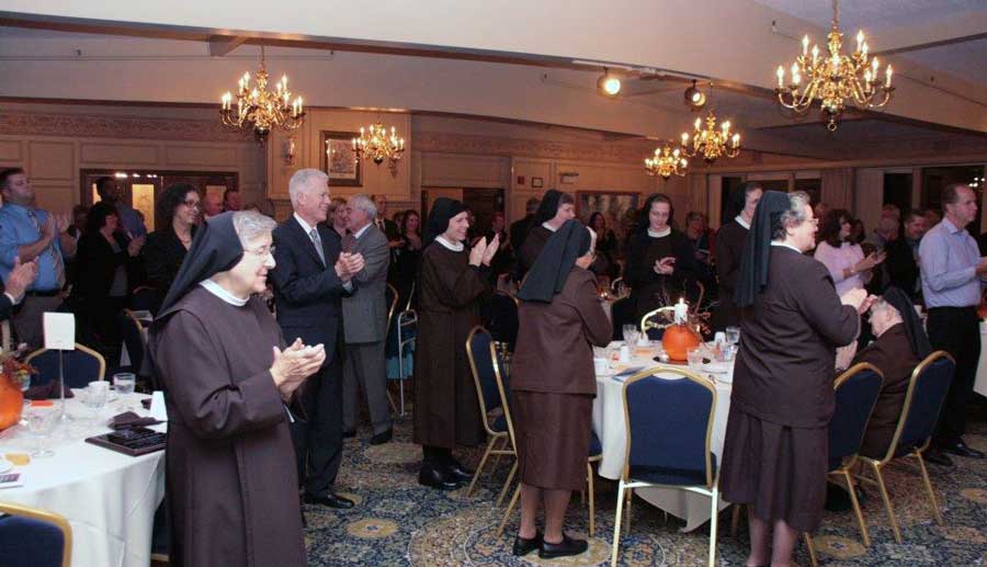 Applause resounds in the dining room; that's Marty Conroy on the left.