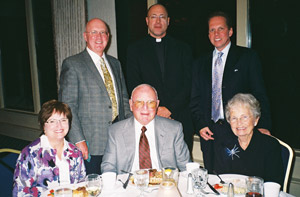 From the left, seated, are Liz Fagan, Joe & Bobbie Noonan; standing are Dr. Mike Fagan, Father Jim Heyd, and Jerry Bern. Father Heyd is a pro-life advocate of the Chicago Archdiocese. He introduces Coleen Mast and speaks of her good works.