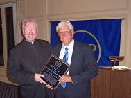 Father Gilligan (left) bestows the Henry Hyde Award on Dr. Richard G. Moutvic