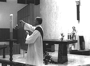 Ray Deabel (left) incenses candle at beginning of Vespers