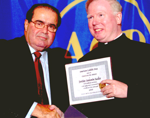 Justice Scalia, accepting the Gratiam Dei Award from Father Gilligan